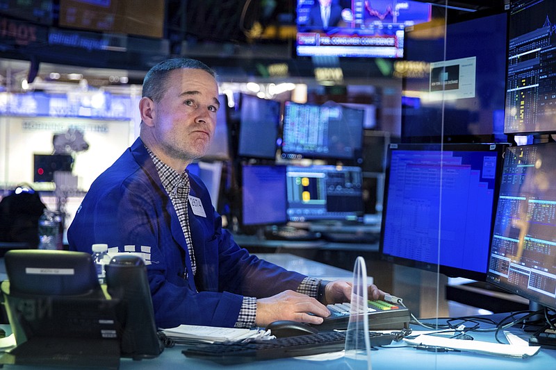 In this photo provided by the New York Stock Exchange, specialist Stephen Naughton works at his post on the trading floor, Tuesday, Feb 22, 2022. Stocks shifted between small gains and losses in morning trading on Wall Street Tuesday as tensions escalated in Ukraine over Russia's decision to send forces into that nation's eastern regions. (Allie Joseph/New York Stock Exchange via AP)