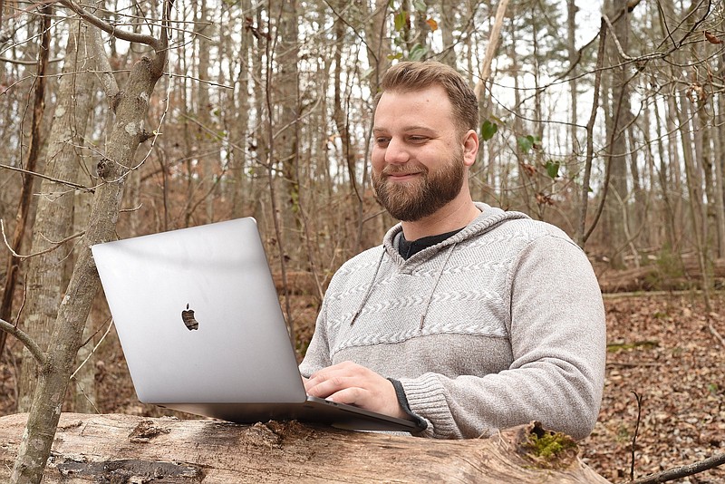 Staff Photo by Matt Hamilton / Joe Hader works in his yard, using a fallen tree as a workstation, at his home in LaFayette, Ga. on Friday, January 28, 2022.