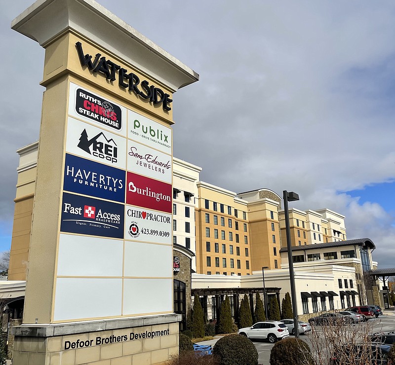 Photo by Dave Flessner / The Village at Waterside, originally developed by the Defoor Brothers, sold most of its commercial sites to the Atlanta-based Stockbridge, although Branch Properties will continue to manage the complex. The Embassy Hotel shown at the entrance to the Waterside development is still owned by the Defoor Brothers.