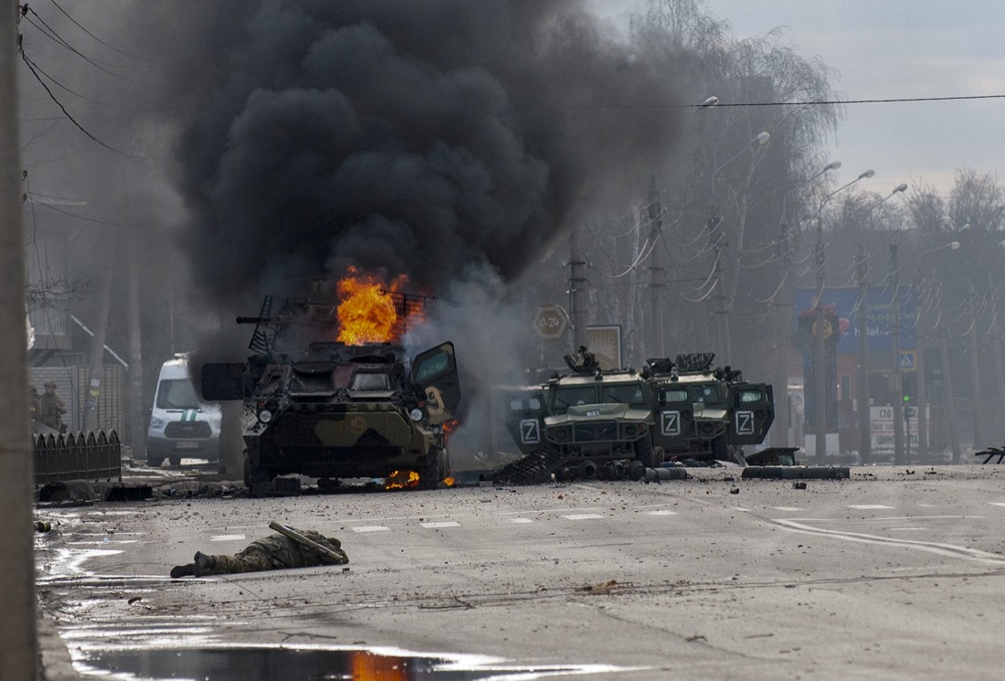 A Russian armored personnel carrier burns amid damaged and abandoned light utility vehicles after fighting in Kharkiv, Ukraine, Sunday, Feb. 27, 2022. The city authorities said that Ukrainian forces engaged in fighting with Russian troops that entered the country's second-largest city on Sunday. (AP Photo/Marienko Andrew)