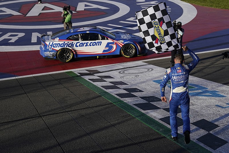 AP photo by Marcio Jose Sanchez / Hendrick Motorsports driver Kyle Larson celebrates after winning Sunday's NASCAR Cup Series race at Auto Club Speedway in Fontana, Calif.