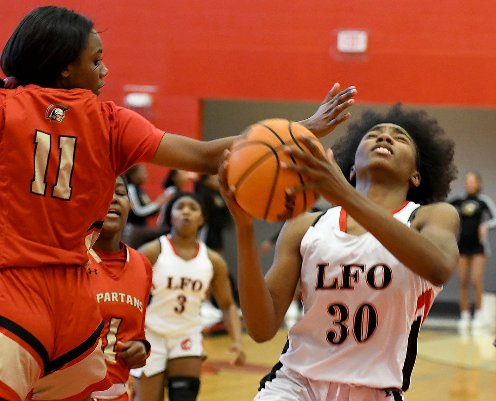 Staff Photo by Robin Rudd / Lakeview's Angel Simmons (30) drives past a GAC defender for the score. The Lakeview Fort Oglethorpe Lady Warriors fell to the Greater Atlanta Christian School Lady Spartans, 67 to 60, in the quarterfinals of the GHSA state tournament on March 1, 2022.