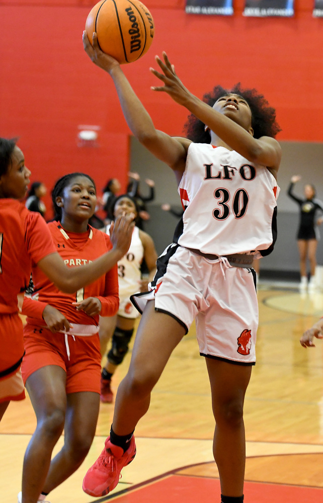 Staff Photo by Robin Rudd / Lakeview's Angel Simmons (30) drives past GAC defenders for the score. The Lakeview Fort Oglethorpe Lady Warriors fell to the Greater Atlanta Christian School Lady Spartans, 67 to 60, in the quarterfinals of the GHSA state tournament on March 1, 2022.