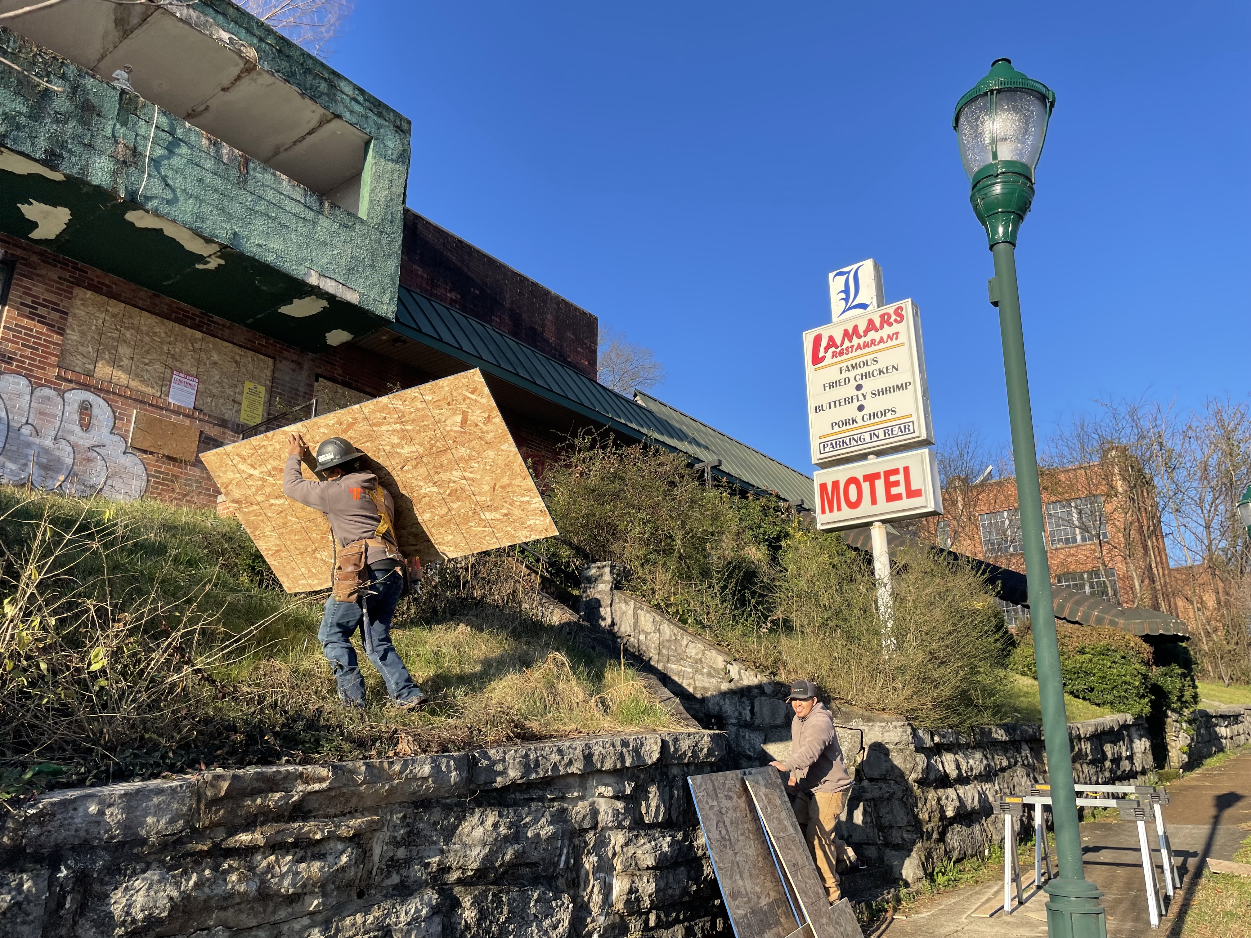 Staff Photo by Dave Flessner / Workers from Tucker Build prepare to board up broken windows as repairs are made to the former Lamar's hotel and restaurant on M.L. King Boulevard. The historic nightclub, which first opened in 1970 but shut down in 2017, was damaged by fire Friday night.
