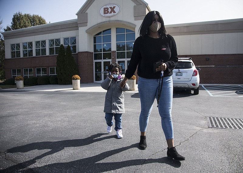Staff photo / Brooke Mitchell and her 4-year-old daughter Zoe Wilson walk out of Brainerd Baptist Crossroad church polling location after voting on Tuesday, Nov. 3, 2020 in Chattanooga, Tenn.