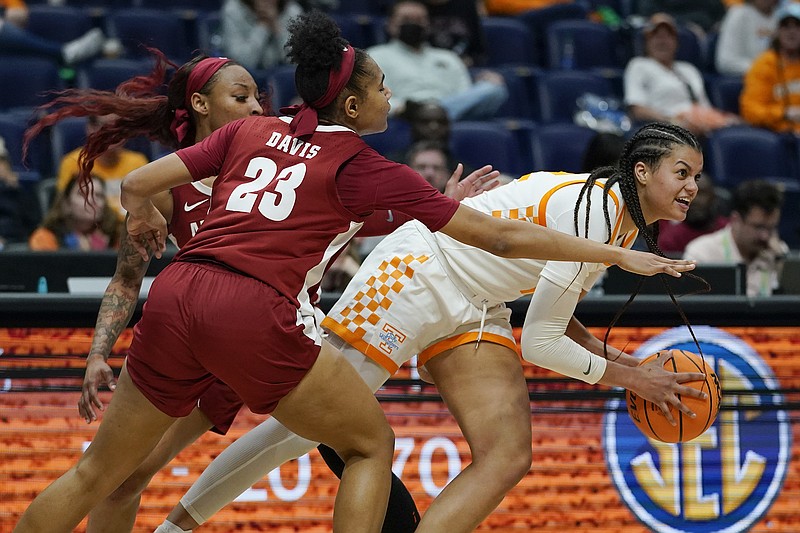 AP photo by Mark Humphrey / Tennessee's Rae Burrell, right, tries to break free from Alabama's Brittany Davis during the second half of an SEC tournament quarterfinal Friday night at Bridgestone Arena in Nashville.