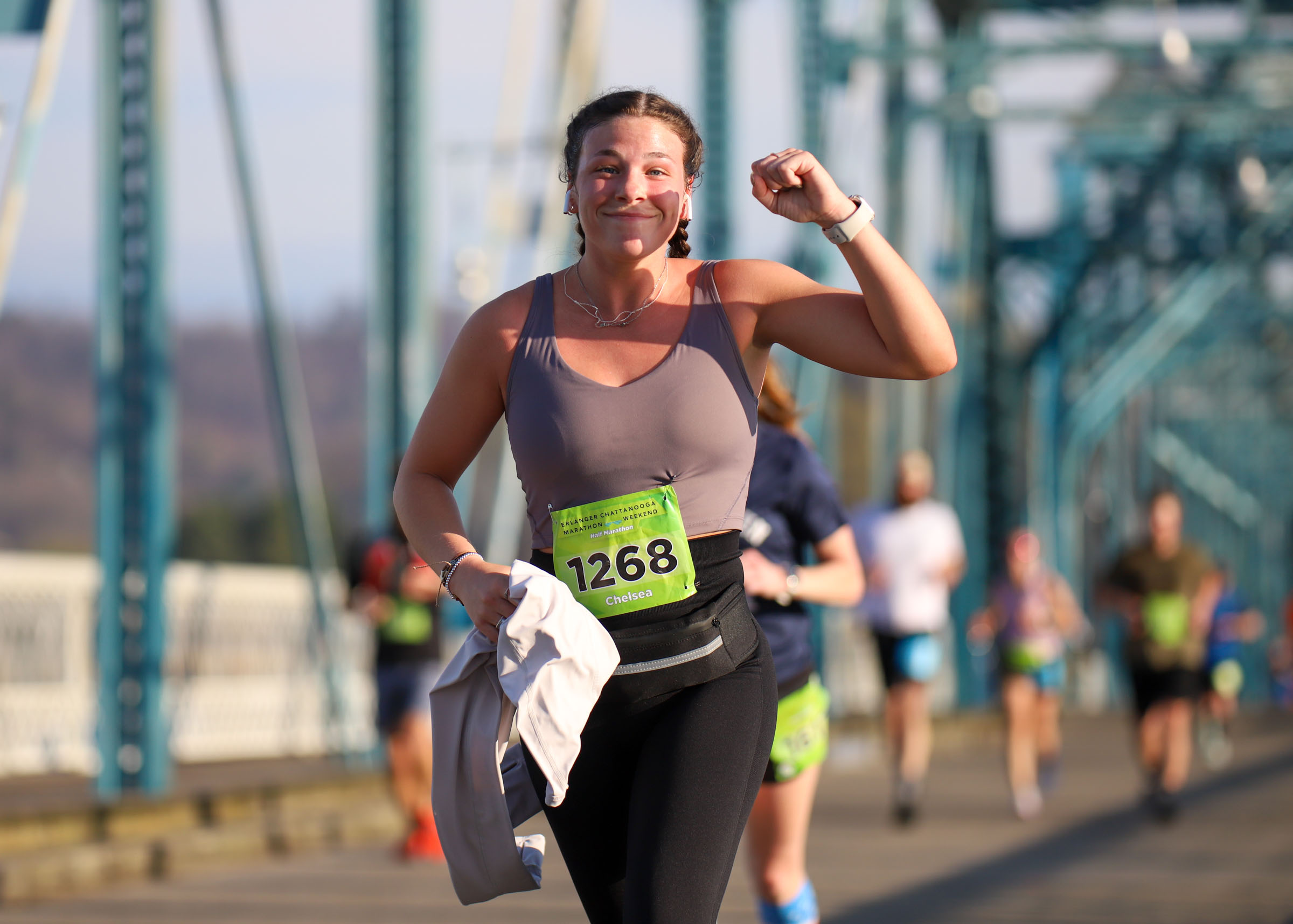 Staff Photo by Olivia Ross / Chelsea Key pumps her fist as she runs across the Walnut Street Bridge on March 6, 2022. The Erlanger Chattanooga Marathon is a full weekend complete with a marathon, half marathon, relays, 5k, and kid's fun run.