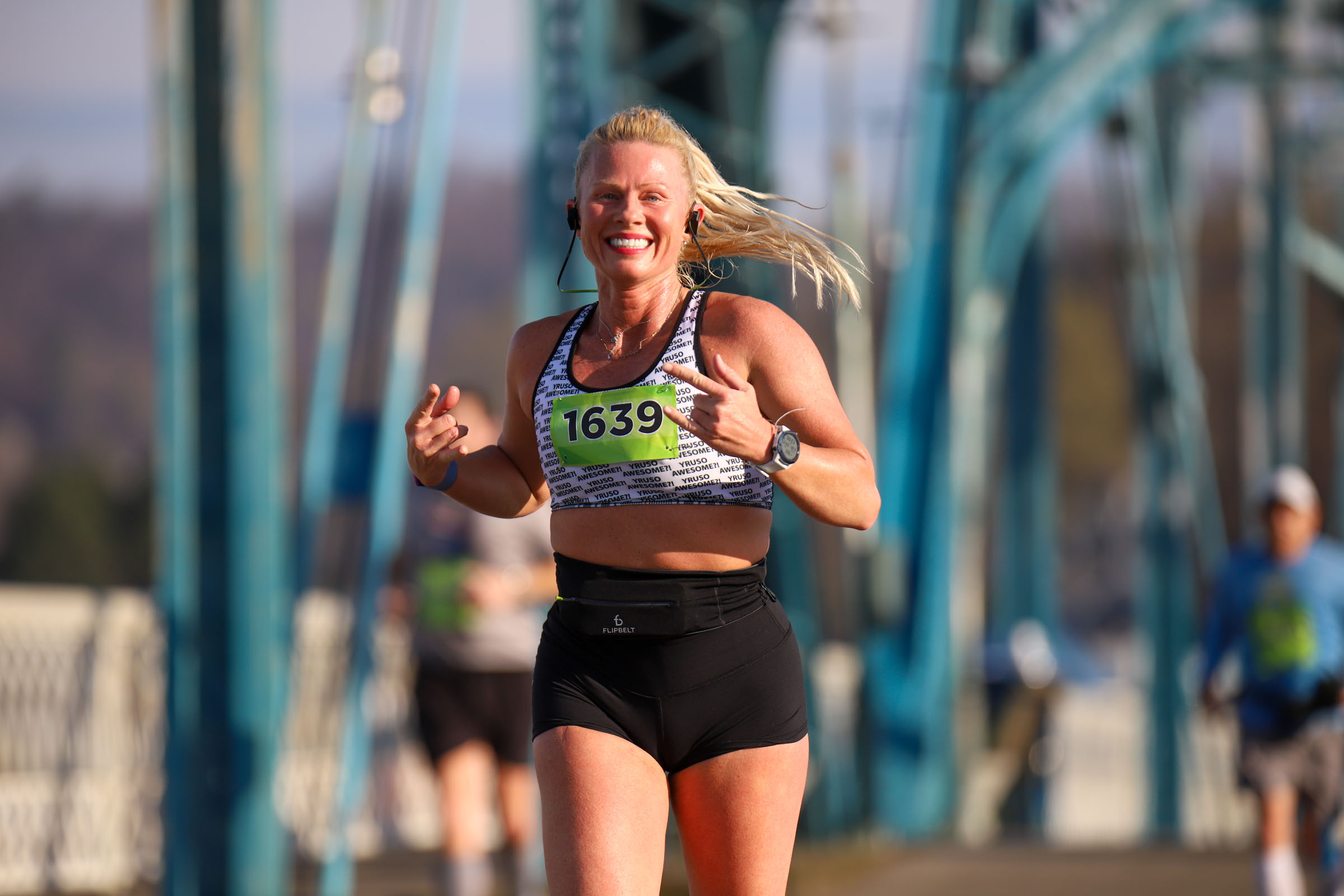 Staff Photo by Olivia Ross / Krystye Dalton smiles as she runs across the Walnut Street Bridge on March 6, 2022. The Erlanger Chattanooga Marathon is a full weekend complete with a marathon, half marathon, relays, 5k, and kid's fun run.
