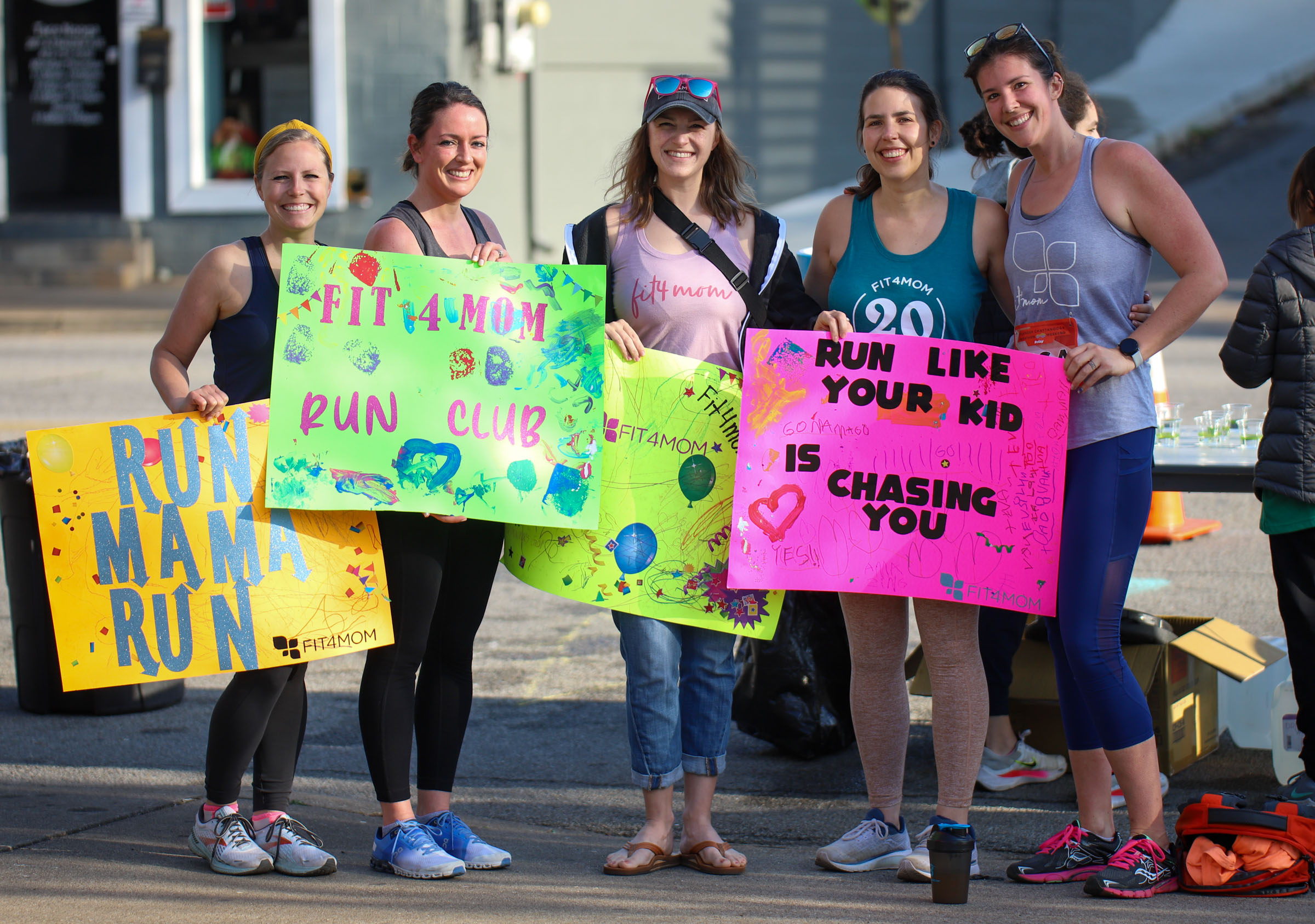 Staff Photo by Olivia Ross / Fit4Mom members hold up encouraging signs during the race on March 6, 2022. The Erlanger Chattanooga Marathon is a full weekend complete with a marathon, half marathon, relays, 5k, and kid's fun run.