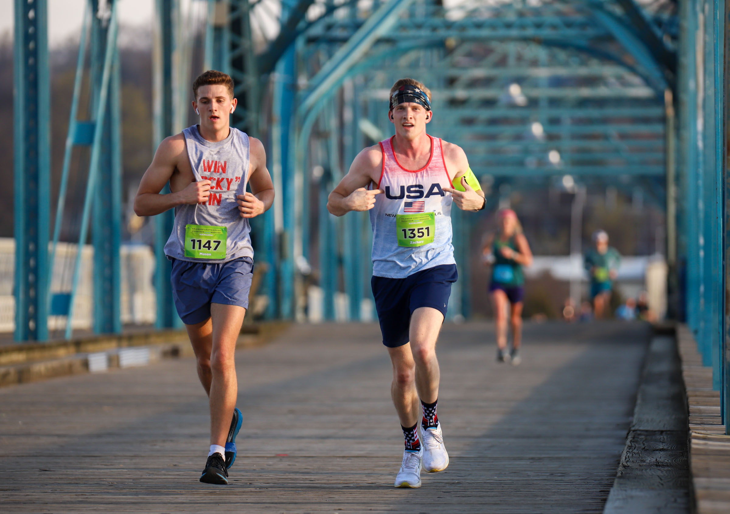 Staff Photo by Olivia Ross / Mason Cunningham and Zachary Read run across the Walnut Street Bridge on March 6, 2022. The Erlanger Chattanooga Marathon is a full weekend complete with a marathon, half marathon, relays, 5k, and kid's fun run.