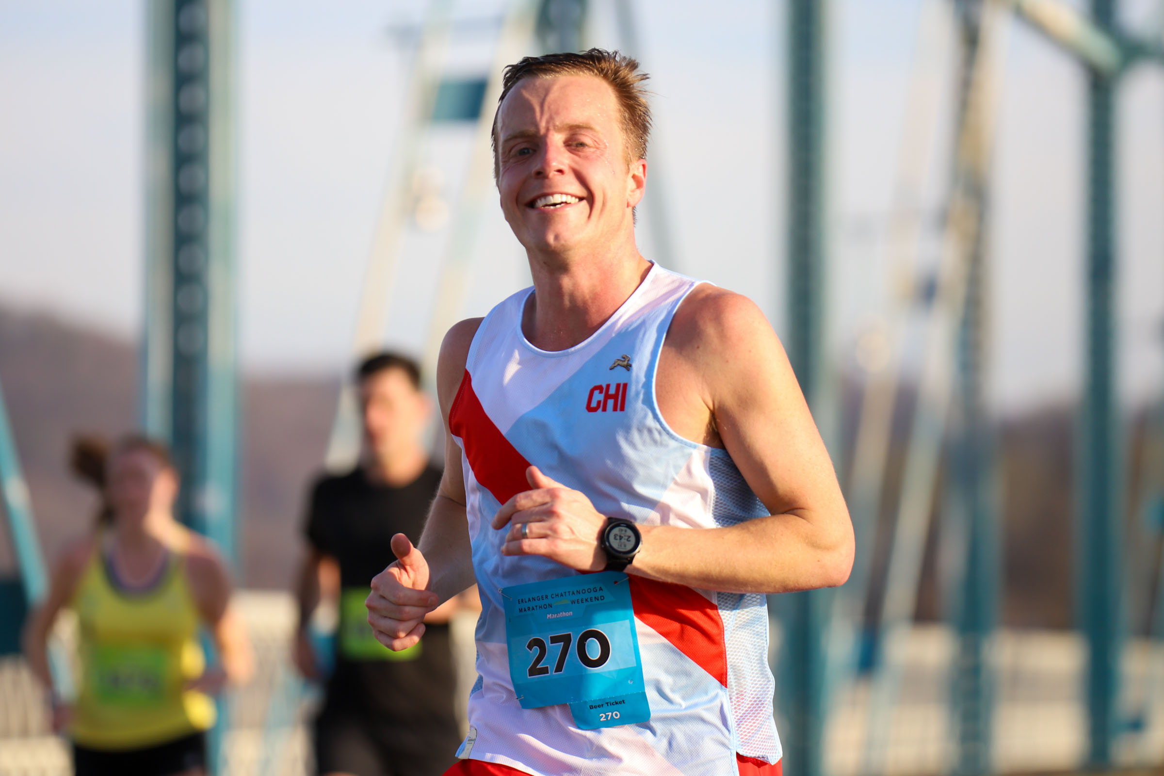 Staff Photo by Olivia Ross / Wilson Gabbard smiles as he runs across the Walnut Street Bridge on March 6, 2022. The Erlanger Chattanooga Marathon is a full weekend complete with a marathon, half marathon, relays, 5k, and kid's fun run.