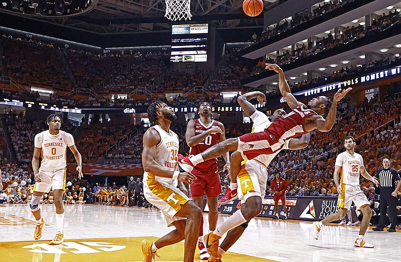 AP photo by Wade Payne / Arkansas guard Chris Lykes falls to the floor as Tennessee guard Josiah-Jordan James (30) looks up for the ball during the second half of the Vols' 78-74 win Saturday in Knoxville. The Vols and Razorbacks enter this week's SEC tournament seeded second and fourth among the 14 teams in Tampa, Fla.