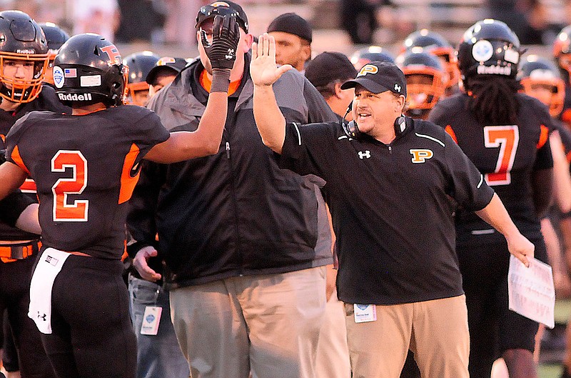 Staff Photo by Robin Rudd /  Game MVP Deandre Kelly (2) is congratulated by co-head coach West Stone duiring the TSSAA Class A football championship in the BlueCross Bowl, at Finley Stadium, on December 3, 2021.