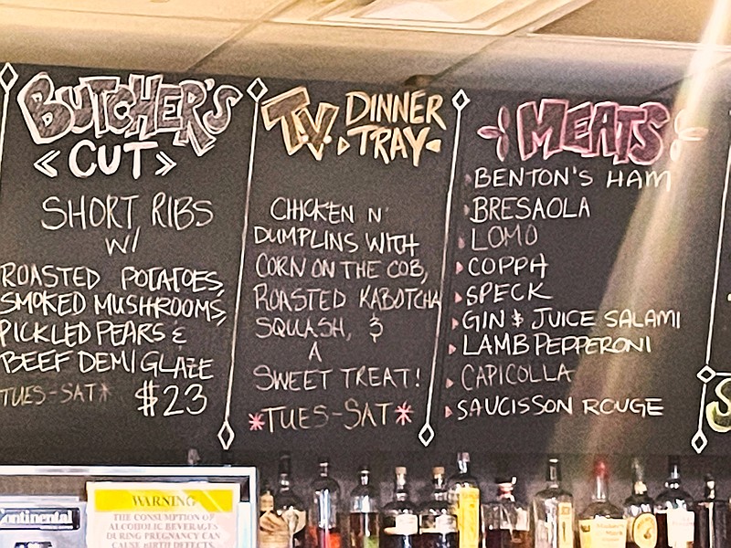 Photo by Anne Braly / A chalkboard above the bar details the day's specials at Wine Down Bistro in Ooltewah.