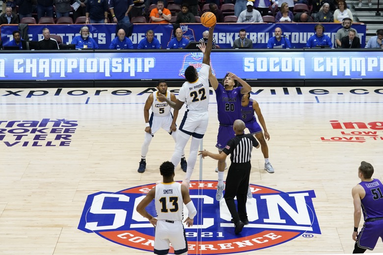 Chattanooga forward Silvio De Sousa (22) and Furman forward Jalen Slawson (20) tip off for the start of the NCAA college basketball championship game for the Southern Conference tournament, Monday, March 7, 2022, in Asheville, N.C. (AP Photo/Kathy Kmonicek)