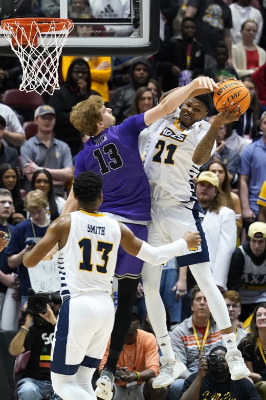 Furman forward Garrett Hien (13) and Chattanooga forward Josh Ayeni (21) battle for a rebound as Chattanooga guard Malachi Smith (13) looks on in the first half of an NCAA college basketball championship game for the Southern Conference tournament, Monday, March 7, 2022, in Asheville, N.C. (AP Photo/Kathy Kmonicek)