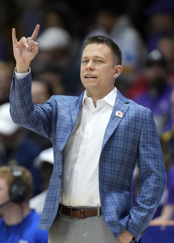 Furman head coach Bob Richey directs his team against Chattanooga in the first half of an NCAA college basketball championship game for the Southern Conference tournament, Monday, March 7, 2022, in Asheville, N.C. (AP Photo/Kathy Kmonicek)