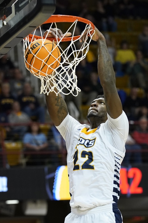 Chattanooga forward Silvio De Sousa (22) dunks against Furman in the second half of an NCAA college basketball championship game for the Southern Conference tournament, Monday, March 7, 2022, in Asheville, N.C. (AP Photo/Kathy Kmonicek)