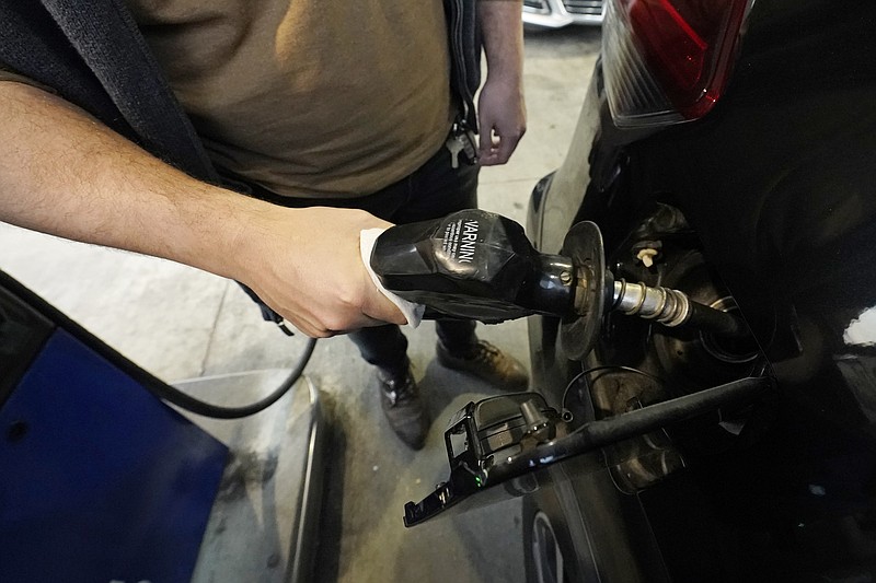 A customer pumps gasoline into his car at a Sam's Club fuel island in Gulfport, Miss., Feb. 19, 2022. The average price for a gallon of gasoline in the U.S. hits a record $4.17 on Tuesday, March 8, as the country prepares to ban Russian oil imports.(AP Photo/Rogelio V. Solis)