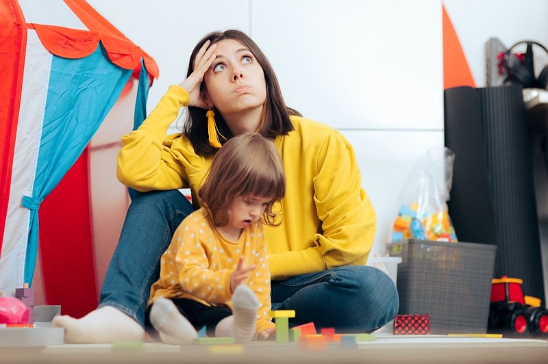 Exhausted overwhelmed mom thinking concerned being stressed and wondering about daily problems parent tile child tile / Getty Images
