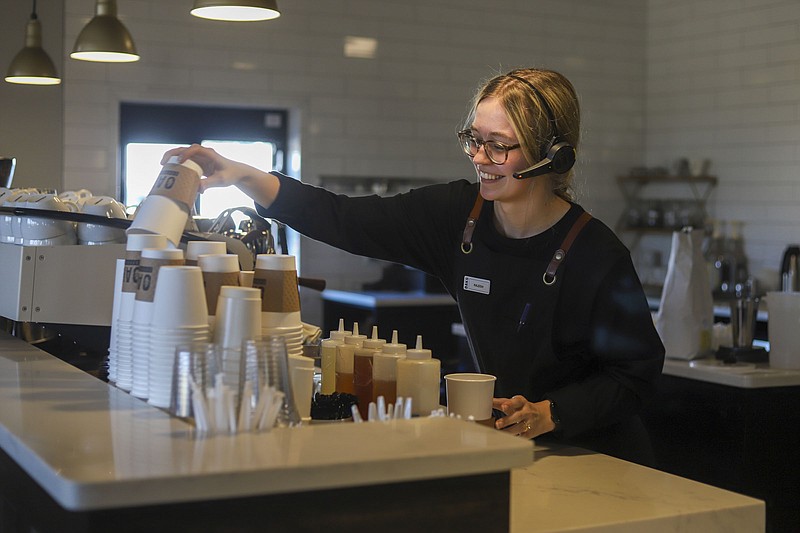 Photo by Olivia Ross / Kaleigh Wagner, barista at Oaks Coffee House, prepares an order for a guest. The business is a non-profit, giving funds back to the community.