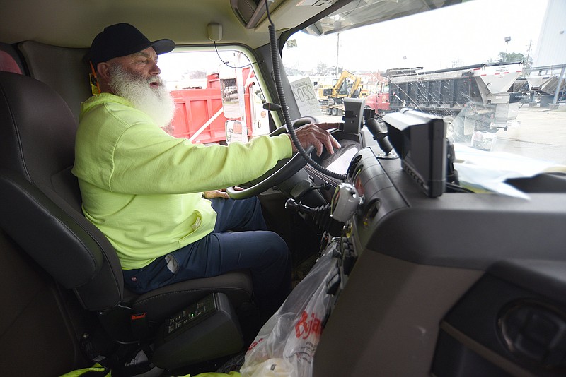 Staff Photo by Matt Hamilton / James Wimpee checks the controls on a truck after a salt spreader was attached at the Public Works Department on East 11th Street on Tuesday, Jan. 5, 2022.