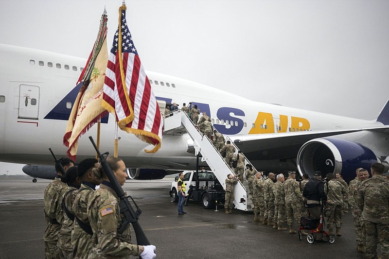 A honor guard stands at attention while a group of soldiers with the U.S. Army's 87th Division Sustainment Support Battalion, 3rd Division Sustainment Brigade, board a chartered plane during their deployment to Europe, Friday, March 11, 2022, at Hunter Army Airfield in Savannah, Ga. The unit is attached to the Army's 3rd Infantry Division out of Fort Stewart, Ga., and will join the 3,800 troops from that division who already deployed in support of NATO in Eastern Europe. (AP Photo/Stephen B. Morton)


