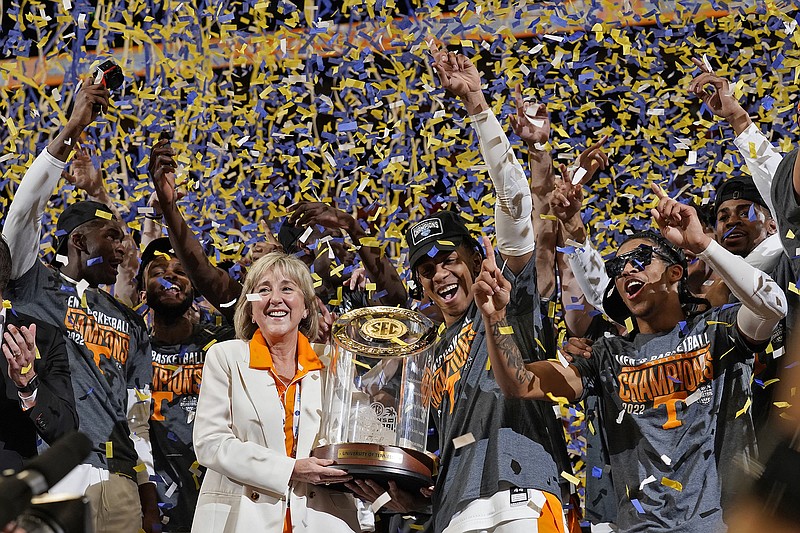 AP photo by Chris O'Meara / Donde Plowman, second from left, chancellor of the University of Tennessee, celebrates with the Vols after they beat Texas A&M to win the SEC tournament title Sunday in Tampa, Fla.