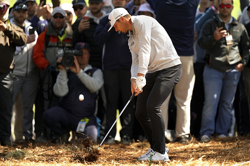 AP photo by Gerald Herbert / Sam Burns hits from pine straw off the 18th fairway of the Stadium Course at TPC Sawgrass during the second round of The Players Championship on Sunday in Ponte Vedra Beach, Fla.