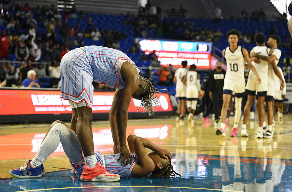 Staff Photo by Matt Hamilton / Brainerd (4) Jakyse Locklin consoles teammate (3) Dennis Lewis Jr. as Power Center Academy players celebrate on Tuesday, March 15, 2022 in Murfreesboro during the opening round of the class 2A boys state basketball tournament at Murphy Center on the campus of Middle Tennessee State University.