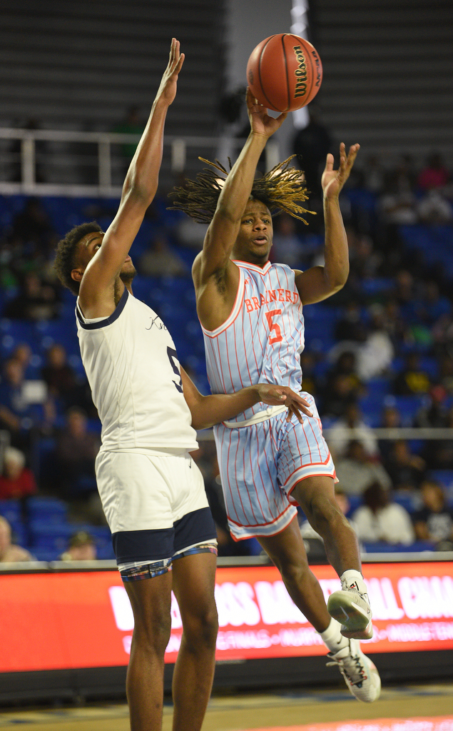 Staff Photo by Matt Hamilton / Power Center Academy (5) Cordarious Sledge defends as Brainerd (5) Keon Wheeler passes the ball to a teammate on Tuesday, March 15, 2022 in Murfreesboro during the opening round of the class 2A boys state basketball tournament at Murphy Center on the campus of Middle Tennessee State University.