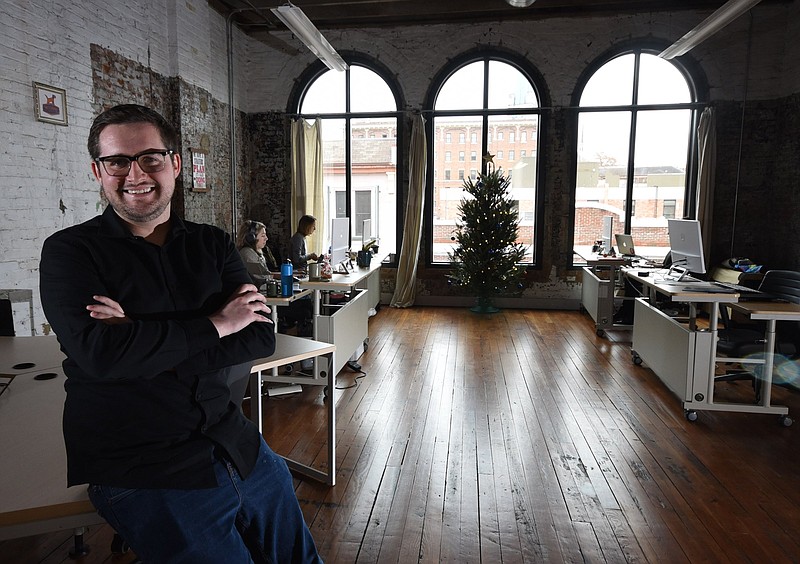 Staff file photo / Max Farrell, CEO of Work Hound, sits in the third floor Cherry Street office workspace in this file photo.