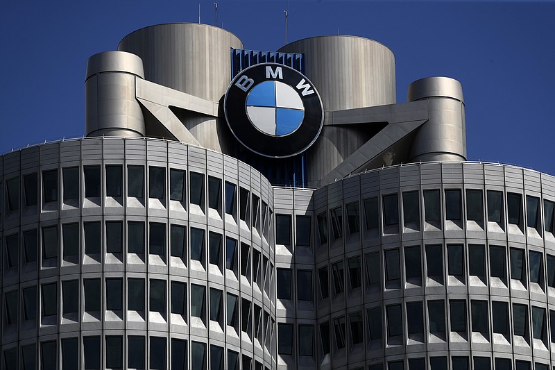 FILE - The logo of German car manufacturer BMW is fixed at the headquarters in Munich, Germany, May 14, 2021. German automaker BMW reports second-quarter earnings on Tuesday Aug. 3, 2021. BMW said Wednesday, March 16, 2022 that bottlenecks at its suppliers in Ukraine have forced it to adjust or interrupt production at a number of factories, which is likely to have a negative impact on auto sales figures. (AP Photo/Matthias Schrader, file)