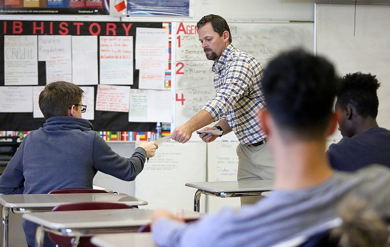 Staff File Photo / An Ooltewah High School teacher passes out tests to students in his classroom in 2019.