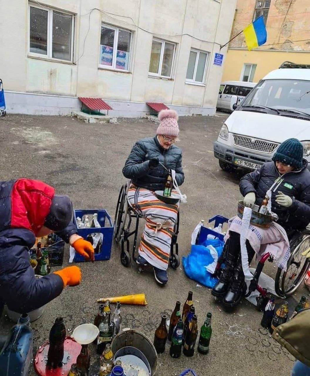 Courtesy Photo by International Ukrainian Crisis Fund / Ukrainian women in wheelchairs gather to make Molotov cocktails, which are bottles filled with fuel and outfitted with a wick, to be used against invading Russian soldiers.