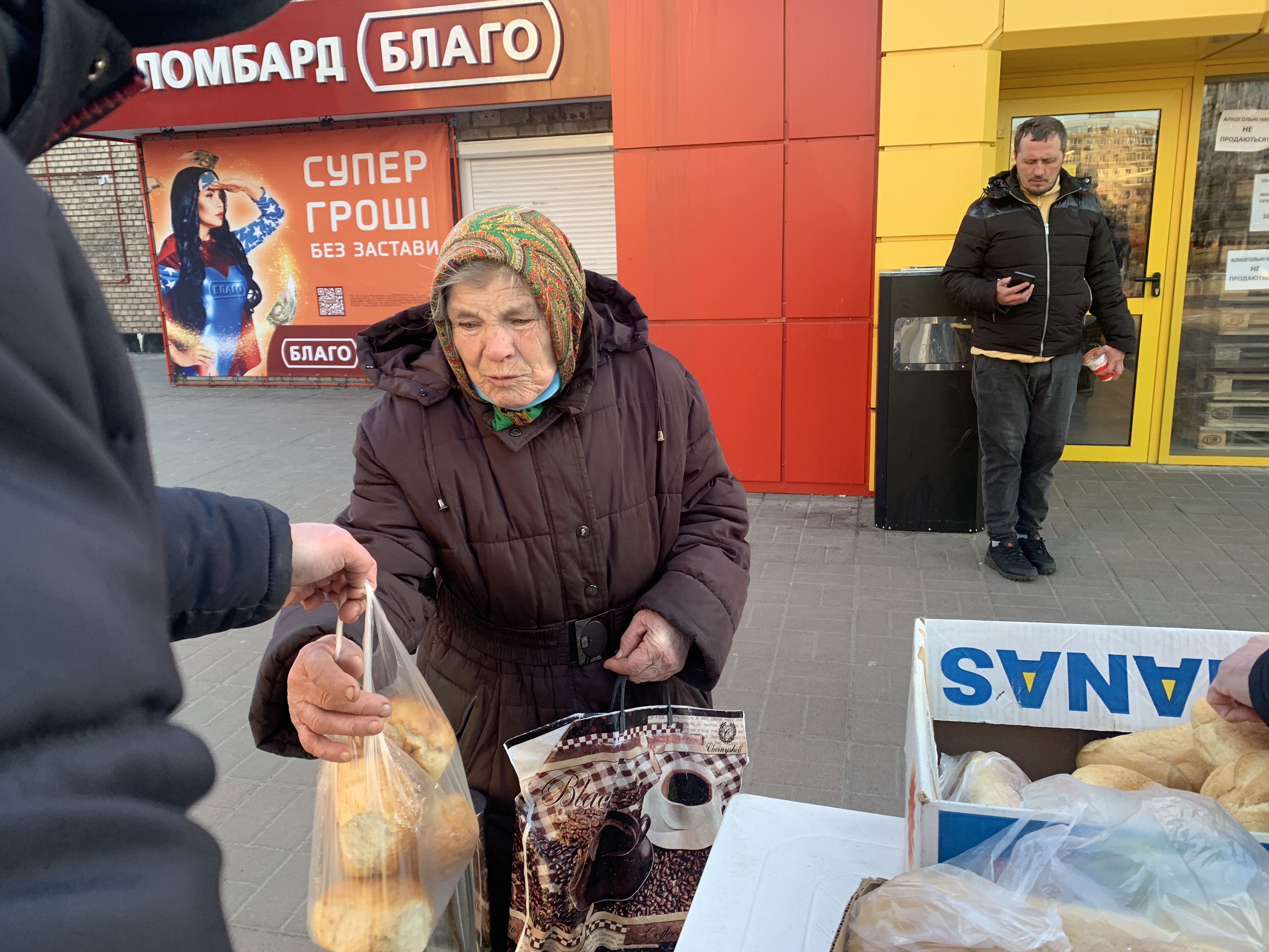 Courtesy Photo by International Ukrainian Crisis Fund / A woman receives relief supplies from the International Ukrainian Crisis Fund.