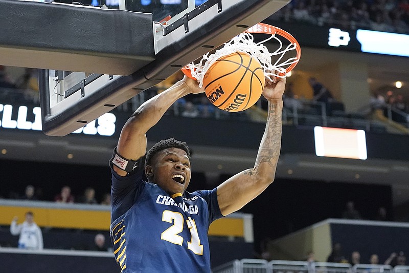 AP photo by Keith Srakocic / UTC's Josh Ayeni dunks during an NCAA tournament first-round game against Illinois on Friday in Pittsburgh.