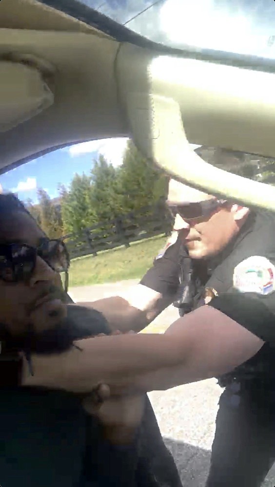 In this image made from video provided by Delane Gordon, a police officer in Collegedale, Tenn., is seen before he fires a stun gun at Gordon on Thursday, March 10, 2022. Gordon, a food delivery driver, began recording his traffic stop for speeding and asked to see the officer's supervisor. Gordon's attorney, Ryan Wheeler, says Gordon is facing additional charges of resisting arrest and obstruction of justice. Police have so far not identified the officer. (Delane Gordon via AP)

