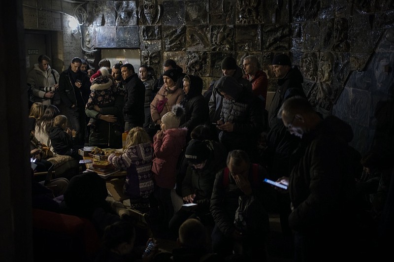 People gather in a basement, used as a bomb shelter, during an air raid in Lviv, Western Ukraine, Saturday, March 19, 2022. (AP Photo/Bernat Armangue)


