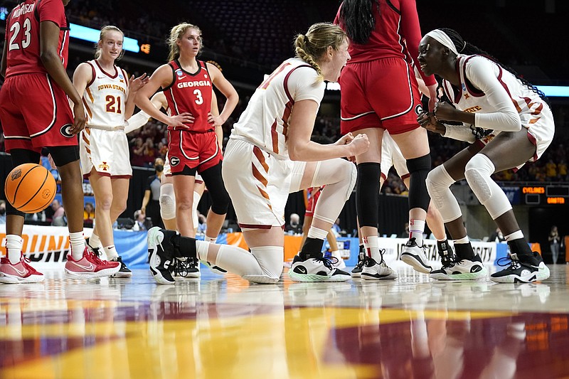 AP photo by Charlie Neibergall / Iowa State forward Morgan Kane, center, celebrates with teammate Nyamer Diew, right, after making a basket during an NCAA tournament second-round game against Georgia on Sunday in Ames, Iowa.