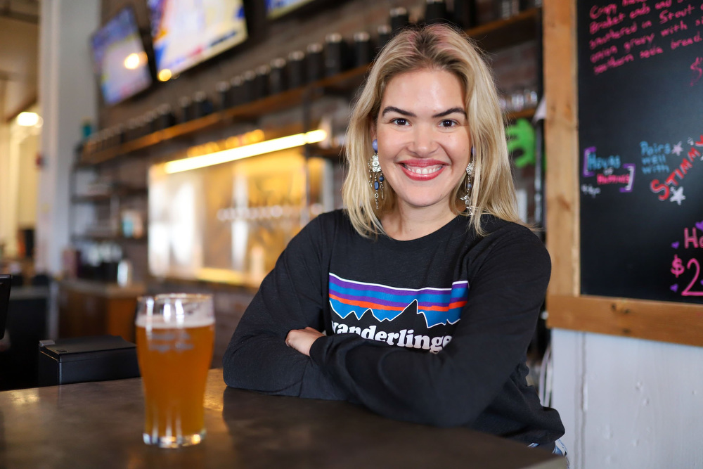 Staff photo by Olivia Ross / Molly Lamb stands near the front entrance at Wanderlinger Brewing Co. on Saturday, March 19, 2022. Lamb is the events coordinator and is spearheading the beer education classes at Wanderlinger.