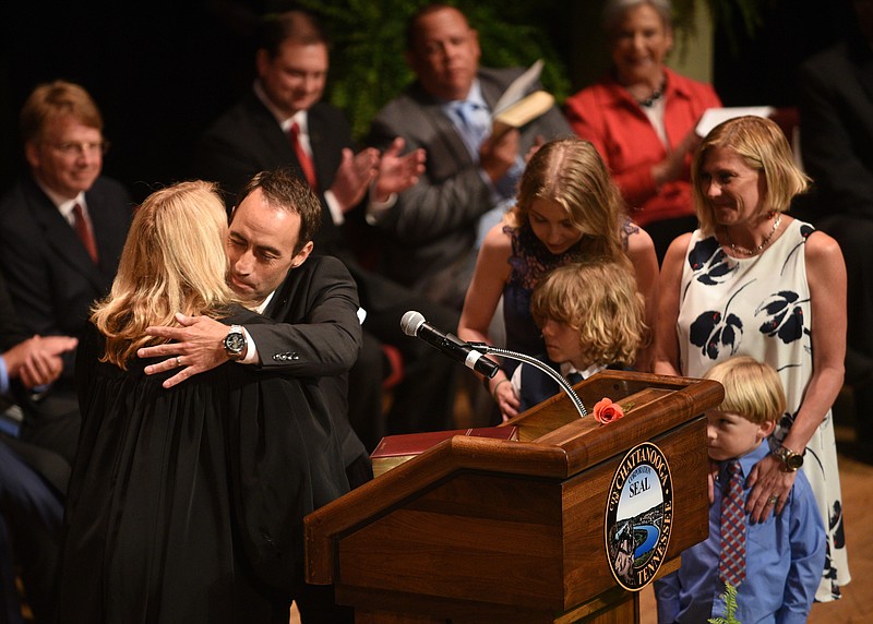 Staff File Photo / Chattanooga City Councilman Ken Smith hugs Judge Christie Sell after he took the oath of office during a ceremony for the mayor and all council members at the Tivoli Theatre in 2017.