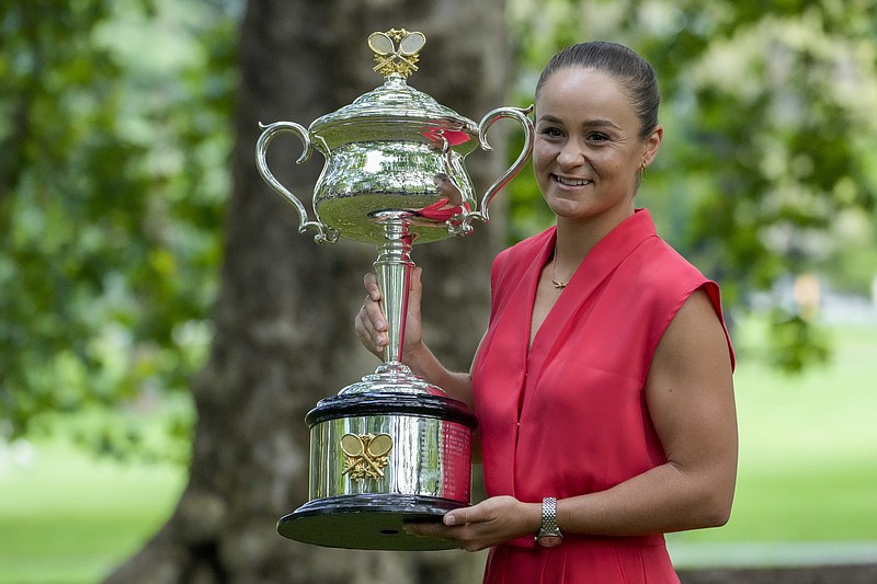 AP photo by Mark Baker / Top-ranked women's tennis star Ash Barty poses with the Daphne Akhurst Memorial Cup the morning after defeating Danielle Collins in the women's singles final at the Australian Open this past January.