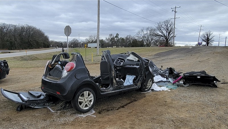 In this image provided by KFOR-TV, a heavily damaged vehicle is seen off a road in Tishomingo, Okla., following a two-vehicle collision in which six teenage students were killed, Tuesday, March 22, 2022. (NewsNation KFOR via AP)