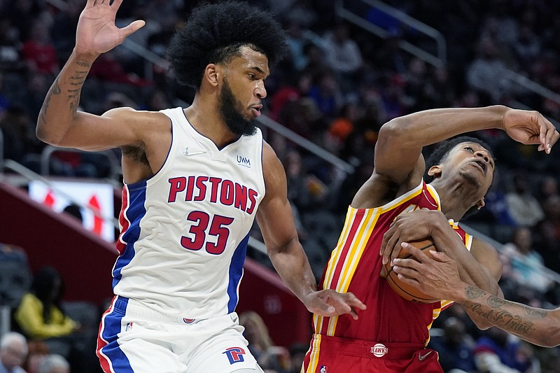 AP photo by Carlos Osorio / Atlanta Hawks forward De'Andre Hunter, right, is fouled next to Detroit Pistons forward Marvin Bagley III on Wednesday in Detroit.