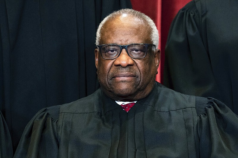 Justice Clarence Thomas sits during a group photo at the Supreme Court in Washington, on Friday, April 23, 2021. Thomas has been hospitalized because of an infection, the Supreme Court said Sunday, March 20, 2022. Thomas, 73, has been at Sibley Memorial Hospital in Washington, D.C., since Friday, March 18 after experiencing "flu-like symptoms," the court said in a statement. (Erin Schaff/The New York Times via AP, Pool, File)