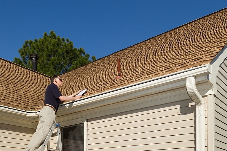 Home inspector examines a residential roof vent pipe. / Getty Images/iStock/SLRadcliffe