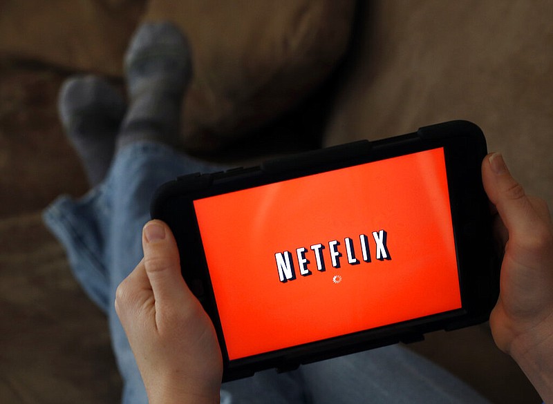 In this Friday, Jan. 17, 2014, file photo, a person displays Netflix on a tablet in North Andover, Mass. (AP Photo/Elise Amendola, File)