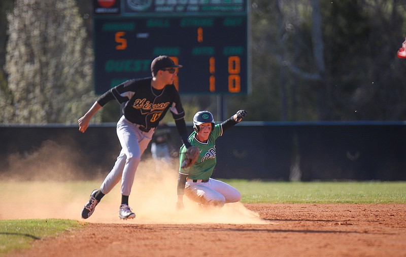 Staff photo by Olivia Ross  / Brayden Jasper slides safely into 2nd as Maddox Russak loses the ball on March 28, 2022. East Hamilton took on Hixson at home. 