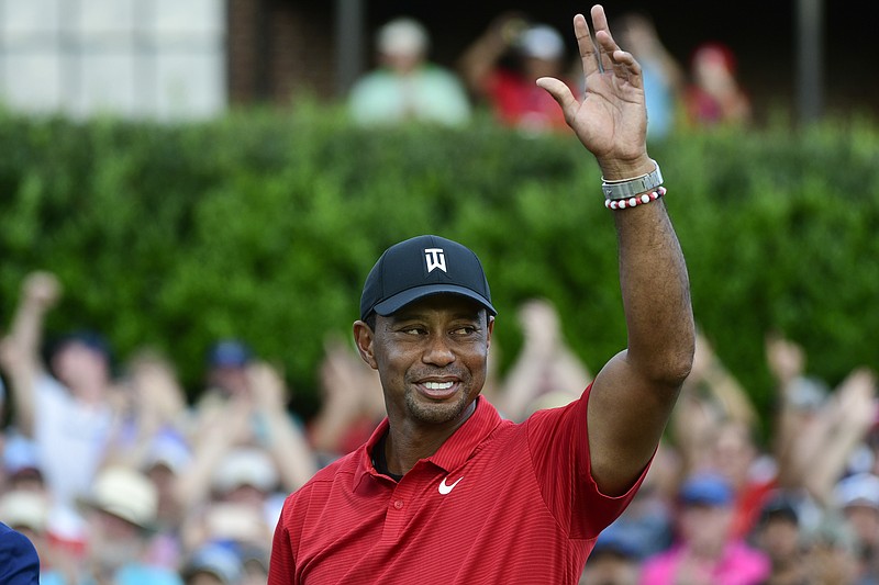 Tiger Woods celebrates on the 18th green after winning the 2018 Tour Championship tournament.